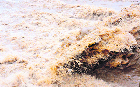 A heavy flow of water in the Ganga in Haridwar on Friday following heavy rain in the upper reaches of Garhwal hills. A flood alert has been sounded in areas along the river.