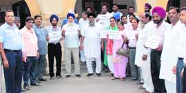 Residents stand outside the Jalandhar Cantonment Board office during the general house meeting on Friday. 
