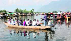 A group of tourists enjoys a boat ride on the Dal Lake in Srinagar on Friday.
