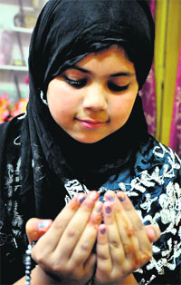 A Muslim girl offers namaz during the holy month of Ramadan in Jammu.