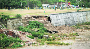 The damaged portion of an embankment that was washed away during the overnight rain in Jammu on Friday.