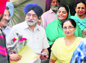 Education Minister Sikander Singh Maluka is welcomed at Government College for Women in Ludhiana on Friday.