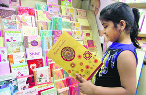 A girl takes a look at a greeting card in a shop 