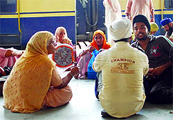 An old woman uses a hand fan to beat the heat at the railway station in Amritsar