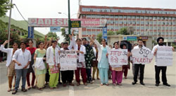 Interns of the Adesh Dental College protest outside the college premises on the Barnala road on Saturday. a tribune photograph