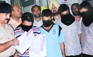 Members of a gang in police custody.