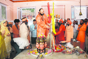 Mahant Deependra Giri picks the Charri Mubarak after prayers in Srinagar