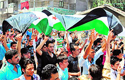 Syrians protest in Aleppo during the funeral of a man killed in the bombardment of Sukari, southwest of the restive city, on Saturday