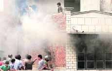 Firemen and people try to douse the fire at a cosmetics shop in Amritsar on Sunday