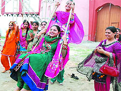 City women enjoy themselves as they participate in the Teej celebrations organised at the Jaipalgarh village in Bathinda on Sunday
