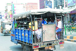 An improvised auto-rickshaw is seen ferrying children to school in Bathinda on Saturday. Despite many efforts, the vehicles carrying children to school are yet to adhere to the norms prescribed by the authorities