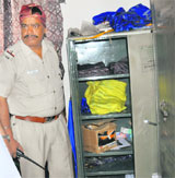 A police official shows the empty almirah at the Sector-20 gurdwara.
