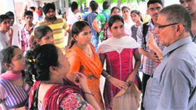 An official explains the admission system to parents and students at the PU auditorium, in Chandigarh on Sunday.