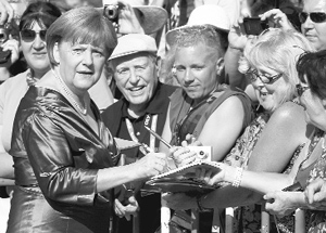 Chancellor Angela Merkel signs autographs in Bayreuth