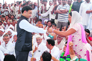 A woman ties rakhi on AITMC leader KD Singhs wrist at the dharna site of farmers at Gorakhpur in Fatehabad on Sunday. 