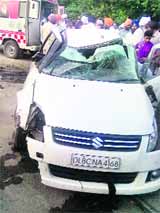 The damaged car after it fell from an overbridge on Sunday.