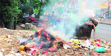 Residents, unable to bear the stench, set garbage on fire in the Majitha Road area in Amritsar on Monday