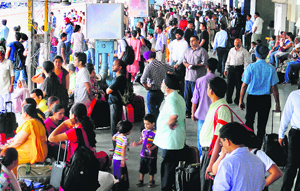 Passengers wait for trains at the Chandigarh railway station on Monday. Several trains were delayed due to power failure.