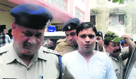Acharya Balkrishna, a close aide of yoga guru Ramdev, being produced in a court in Dehradun on Monday.