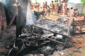 Vehicles torched by villagers protesting against the acquisition of their land in Rewari recently.