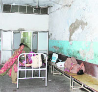 Patients at the Maternity Ward of the Civil Hospital return to the corridors due to the stench and muck inside the old ward in Jalandhar.