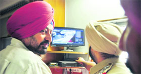 Police officials scan the CCTV footage in Ludhiana on Monday.