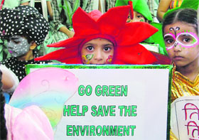 Students of Green Senior Secondary Public School paint their faces and prepare posters on the theme "Save Environment" in Ludhiana.