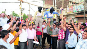 Members of the Anti-Active Corruption Group hold a protest against MC officials and contractor of the Gunda Nullah covering project in Ludhiana on Monday.
