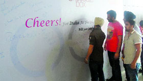 Residents write messages in support of the Indian Olympics players in Ludhiana.