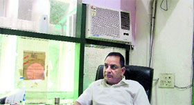 The air-conditioner is on in the cabin of Rajesh Kumar Mehra, Executive Magistrate, Suvidha centre.