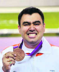 Gagan Narang poses for photographs after winning bronze in 10m air rifle event on Monday. 