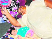 With the Northern Grid tripping for the second time in as many days, a woman brings out his day-old grandson on the verandah of the Civil Hospital to beat the heat in Amritsar on Tuesday. photo: vishal kumar 