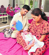 A couple fans their four-day-old baby at the children ward of the Civil Hospital, Phase VI, Mohali, on Tuesday. 