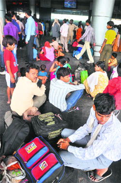 Passengers wait for their trains following a power grid failure at the Chandigarh railway station on Tuesday.
