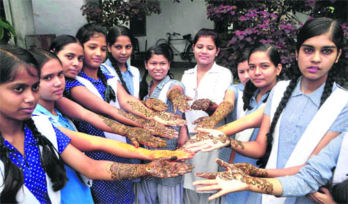 Students of Phool Chand Nari Shilp Niketan participate in a mehndi competition in Dehradun on Tuesday. 
