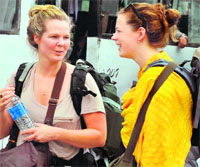 Two foreigners waiting for a Rishikesh-bound bus at the bus stand in Haridwar on Tuesday. Tribune photo: Rameshwar Gaur
