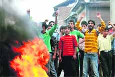 Youngsters protest the killing of a youth in Shopian on Tuesday. 