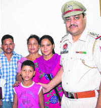 SHO Ashok Kumar with Krishna and his relatives at the police station in Ludhiana on Tuesday.