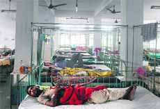 Patients lie in their beds during a power cut at a hospital in Siliguri on Tuesday. 