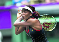 Venus Williams of the US returns the ball to Canada's Aleksandra Wozniak in Wimbledon on Tuesday.  AFP