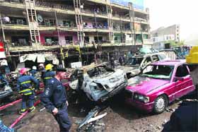 Security forces at the scene of a car bomb in Baghdad, Iraq, on Tuesday. Twin car bombings within five minutes killed 20 persons and injured 57 others. 
