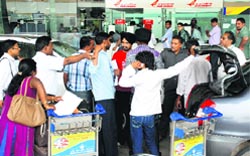 Passengers return following the failure of a Delhi-bound AI flight to land in Chandigarh on Wednesday. Tribune photo: nitin mittal