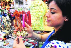 A girl takes a look at Rakhis in a shop at Chandigarh on Wednesday. Tribune photo: S Chandan