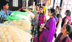 Women buy sweets on the eve of Raksha Bandhan at Sector 22 in Chandigarh on Wednesday. tribune photo: Parvesh Chauhan