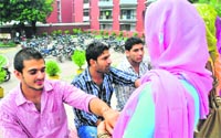 HIV positive women tie Rakhi to PU students in Chandigarh on Wednesday. Tribune photo: S Chandan