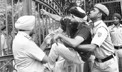 A protester tries to climb a gate as police restricts him at the Punjab School Education Board in Mohali on Wednesday. Tribune photo: Vicky Gharu 
