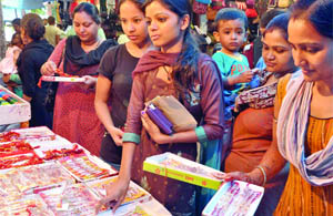 Girls buy rakhis on the eve of Raksha Bandhan in New Delhi on Wednesday.