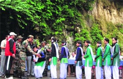 Col HS Rana from the Eco Task Force distributes saplings among students in Mussoorie.
