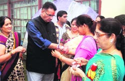 BJP womens wing workers tie rakhis on the wrist of Musosorie MLA Ganesh Joshi on Wednesday.