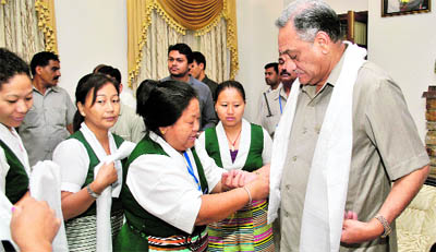 Tibetan women tie rakhis on the wrist of Chief Minister Vijay Bahuguna in Dehradun on Wednesday. 